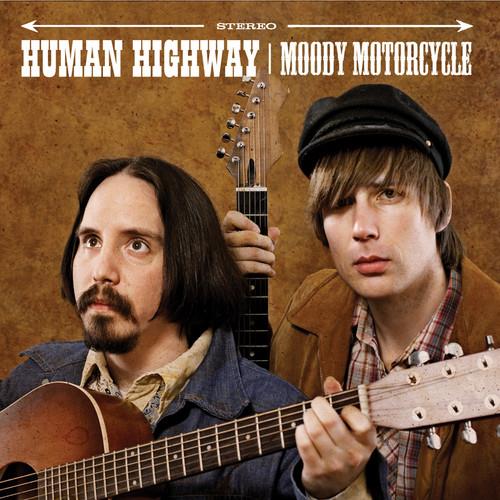 Two men holding acoustic guitars against a brown textured background