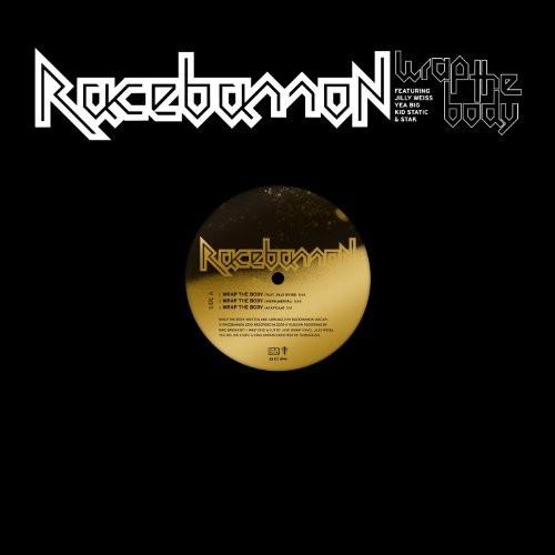 Black vinyl record with gold center label and white band logo on black sleeve