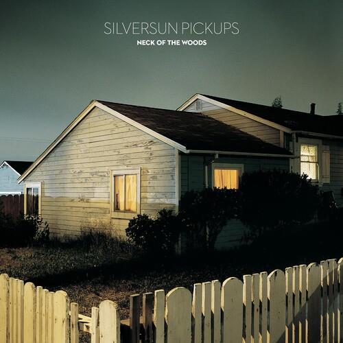 Album cover showing a white house with lit windows behind a picket fence at dusk