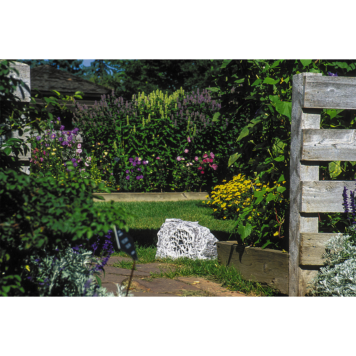 Grey outdoor rock speaker with 6.5-inch woofer and weather-resistant design