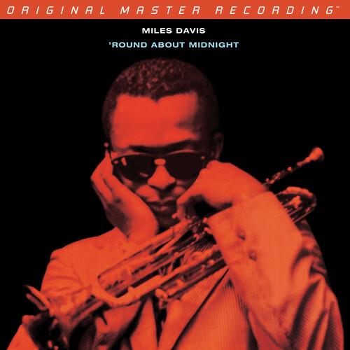 Vinyl LP cover featuring a red-tinted portrait of a man in sunglasses holding a trumpet