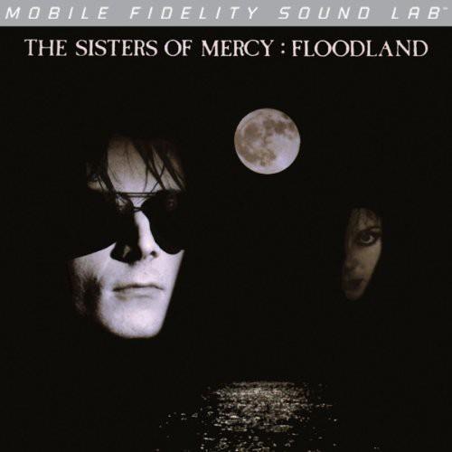 Dark album cover featuring a man in sunglasses, a full moon, and a second face in shadow