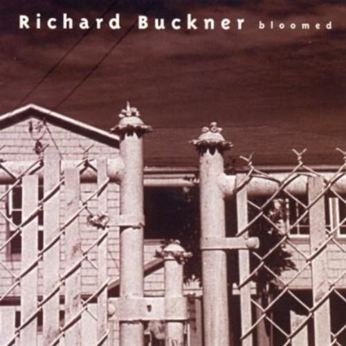 Sepia-toned album cover featuring industrial pipes behind a chain-link fence