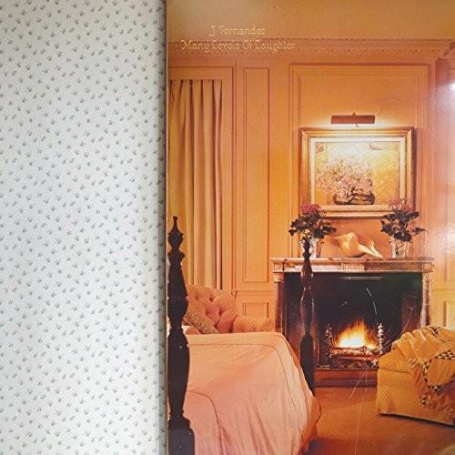 Warm-toned bedroom scene with a lit fireplace, floral painting, and tufted headboard
