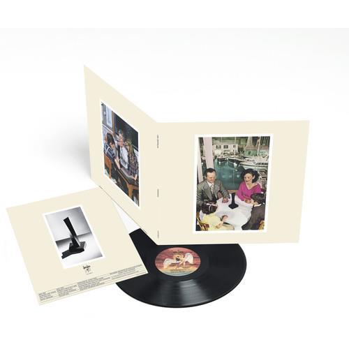 Open gatefold vinyl LP with black record and photo inserts