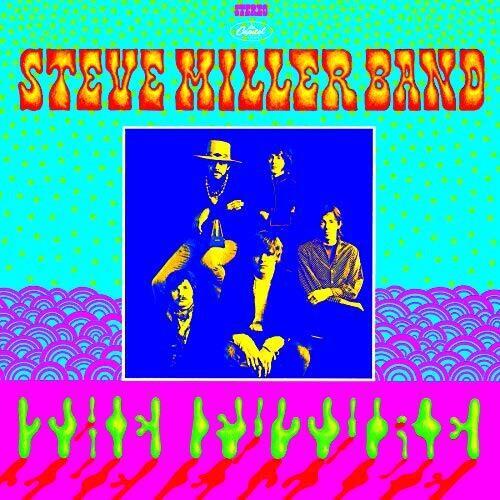 Psychedelic album cover featuring a blue-tinted band photo against a teal and pink patterned backgro