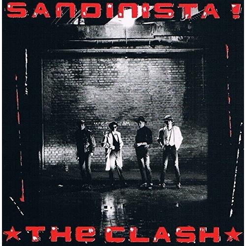 Black and white album cover featuring four band members standing in a brick alleyway