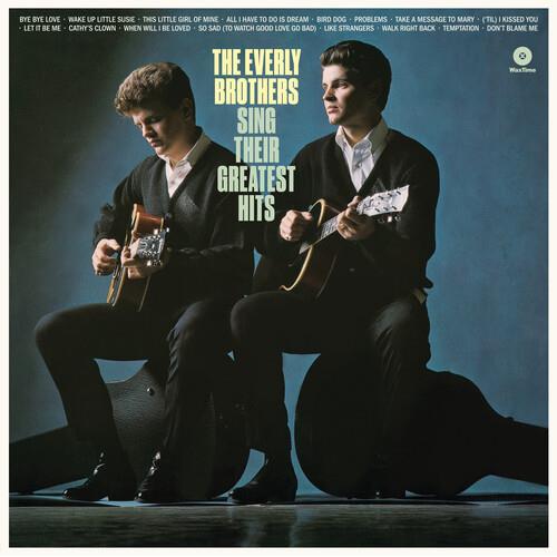 Two men in dark suits playing acoustic guitars on a blue album cover
