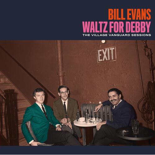 Three men in suits seated at a table in a dimly lit club with an exit sign on the wall