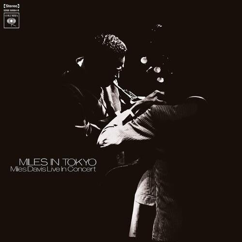 Black and white album cover featuring a musician playing trumpet on a dark stage