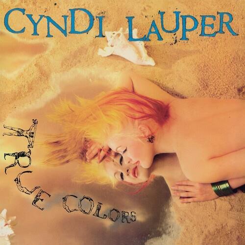 Album cover featuring a woman with blonde hair lying on sand with a seashell