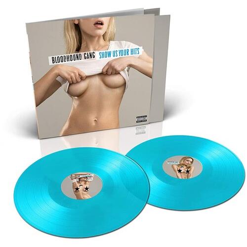 Turquoise vinyl records displayed in front of album cover featuring a woman lifting her shirt