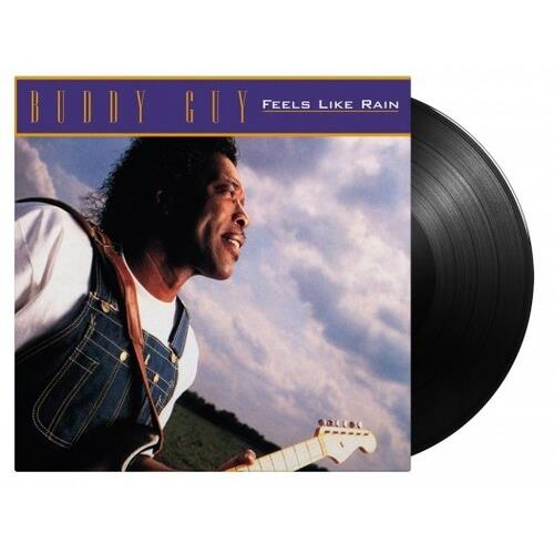 Black vinyl record partially removed from album sleeve showing a man in denim overalls playing a whi