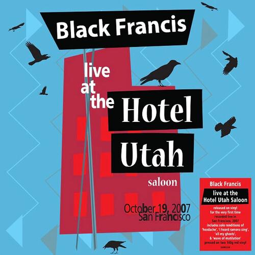 Red vinyl LP cover featuring a stylized blue and red building with black bird silhouettes