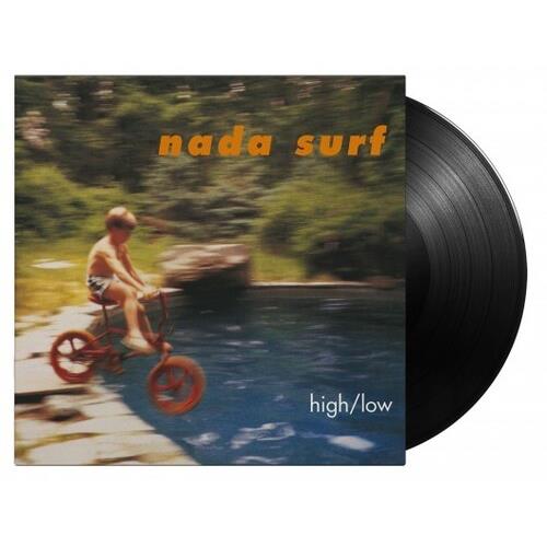 Black vinyl LP partially removed from album sleeve showing a child on a bicycle near water