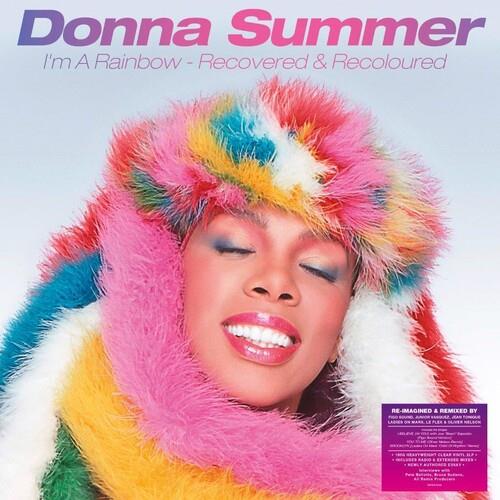 Woman wearing a multicolored faux fur hood with pink, yellow, blue, and white sections