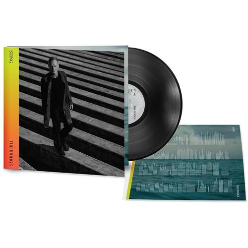 Black vinyl record with album cover showing a man on stairs and a lyric insert