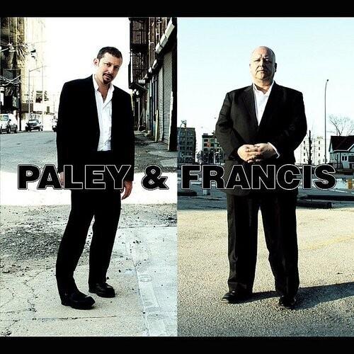Split album cover featuring two men in black suits standing on city streets