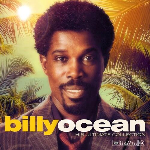 Portrait of a man with an afro and mustache against a tropical palm leaf background