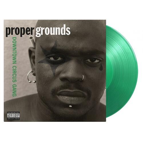Translucent green colored vinyl record partially removed from its sleeve featuring a black and white