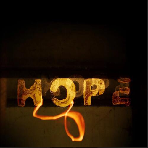 Yellow vinyl record with the word "HOPE" in textured gold lettering