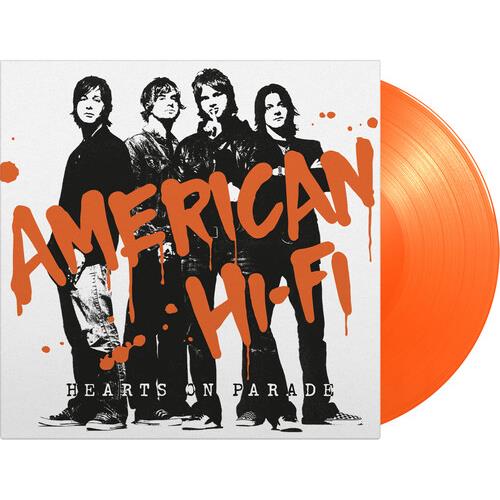 Orange colored vinyl record with white album cover featuring four band members and orange splatter t