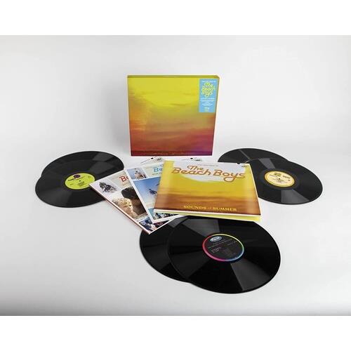 Yellow and orange box set with six black vinyl records and printed booklets