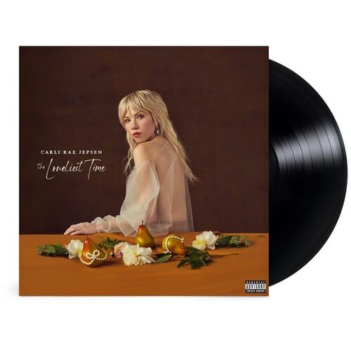Vinyl LP with a cover featuring a blonde woman in a sheer blouse seated at a table with flowers and