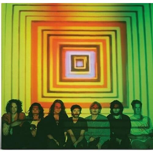 Psychedelic vinyl LP cover featuring a band seated before a colorful concentric square pattern
