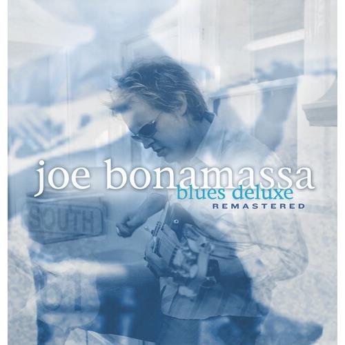 Blue-tinted album cover featuring a guitarist in sunglasses playing a hollow-body electric guitar