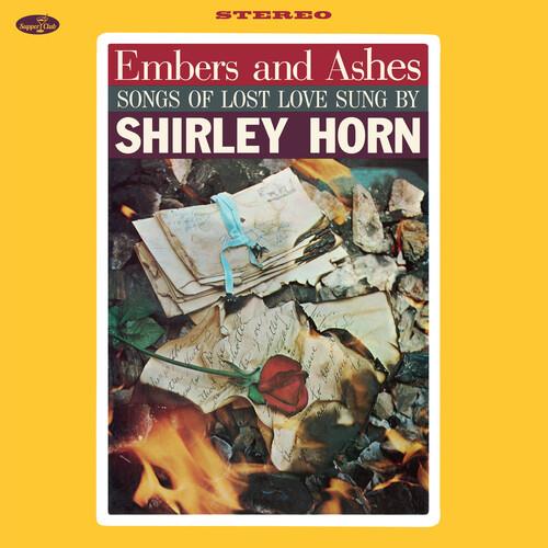 Vinyl LP cover with a yellow border featuring a stack of burned letters tied with a blue ribbon and