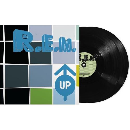 Black vinyl record partially removed from a sleeve with a blue and green grid design