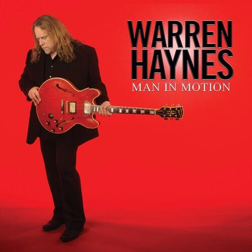 Red translucent vinyl record sleeve featuring a man holding a red electric guitar against a solid re