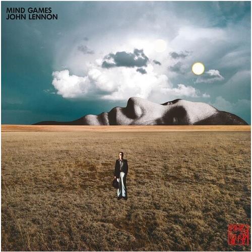 Surreal album cover featuring a man standing in a grassy field beneath a reclining stone figure