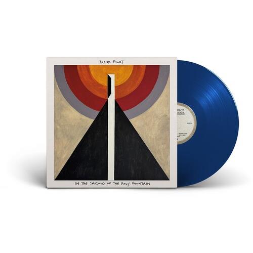 Blue vinyl record partially removed from a white album sleeve featuring abstract geometric artwork