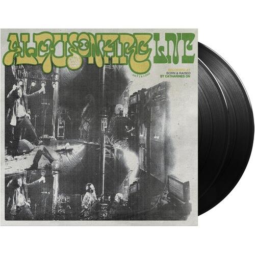 Black vinyl record partially removed from a white sleeve featuring a black-and-white band photo and