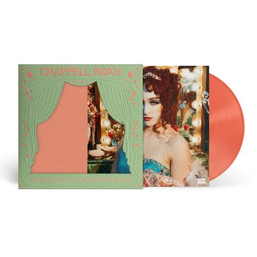 Peach colored vinyl record partially removed from a green gatefold sleeve with a cutout window