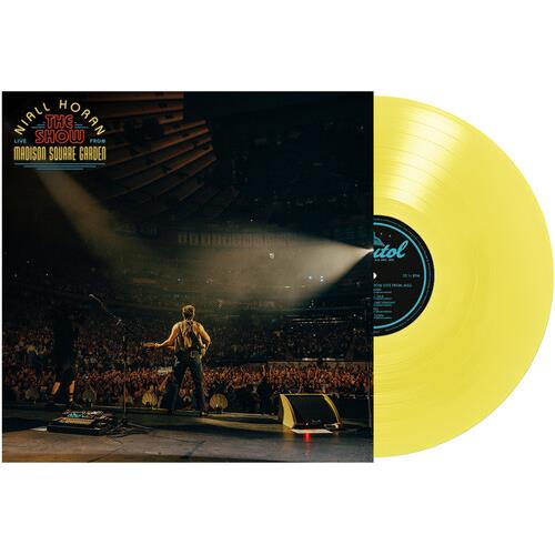 Translucent yellow vinyl record displayed next to album cover showing a performer on stage