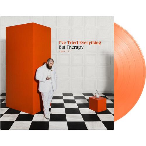 Orange vinyl LP with album cover art featuring a man in a white suit leaning against a tall orange b