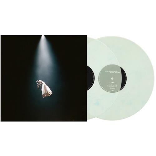 Translucent marble vinyl records displayed next to a black album cover featuring a spotlight