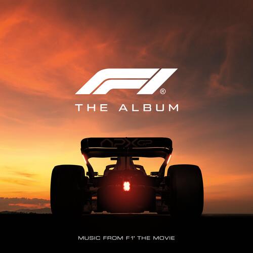 Silhouette of a Formula 1 race car against a vibrant orange sunset sky
