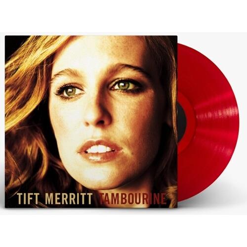 Translucent red vinyl record partially removed from album sleeve featuring a close-up portrait