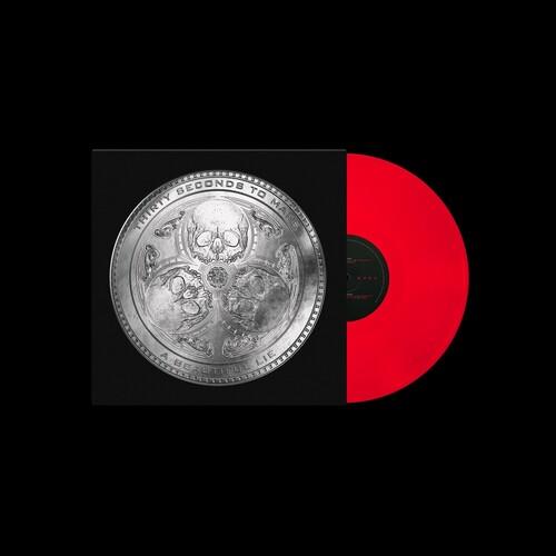 Red vinyl record partially removed from black sleeve featuring a silver circular medallion design