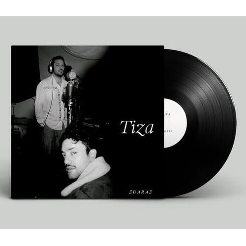 Black vinyl record with a black and white sleeve featuring two men in a recording studio