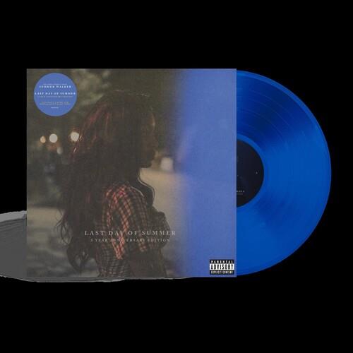 Translucent blue vinyl record partially removed from its album sleeve featuring a woman in a plaid s