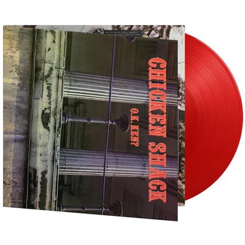 Red colored vinyl record partially removed from album sleeve featuring a street lamp and building fa