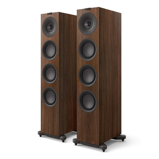 Pair of walnut wood floorstanding speakers with four black drivers and stabilizing feet