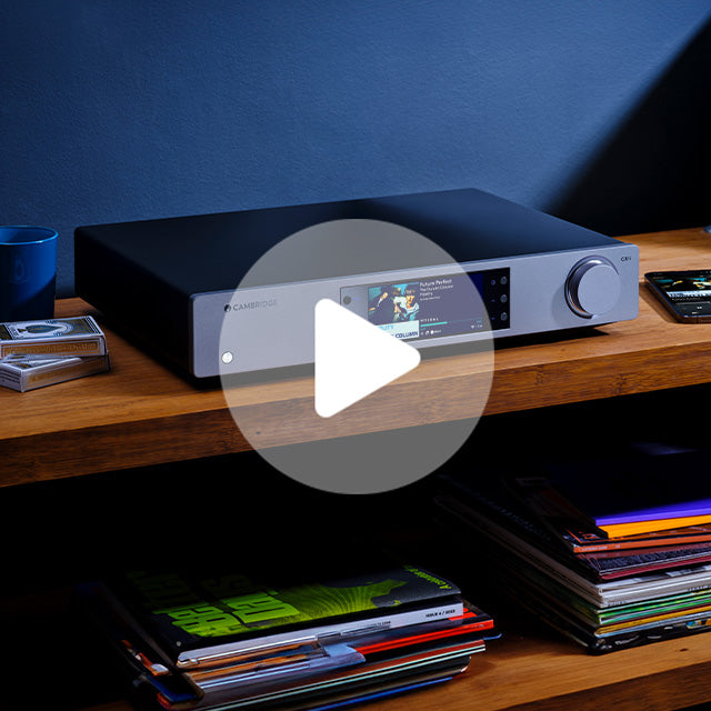 Silver and black Cambridge Audio CXN100 network streamer with color display and volume knob on woode
