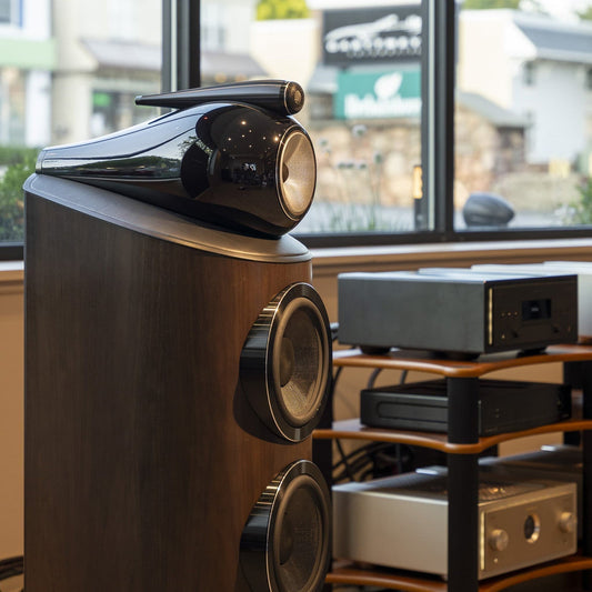 Walnut wood floorstanding speaker with glossy black curved top and dual front woofers