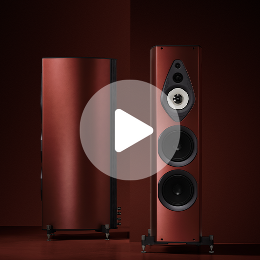 Pair of tall floorstanding speakers with glossy red cabinets and black driver cones